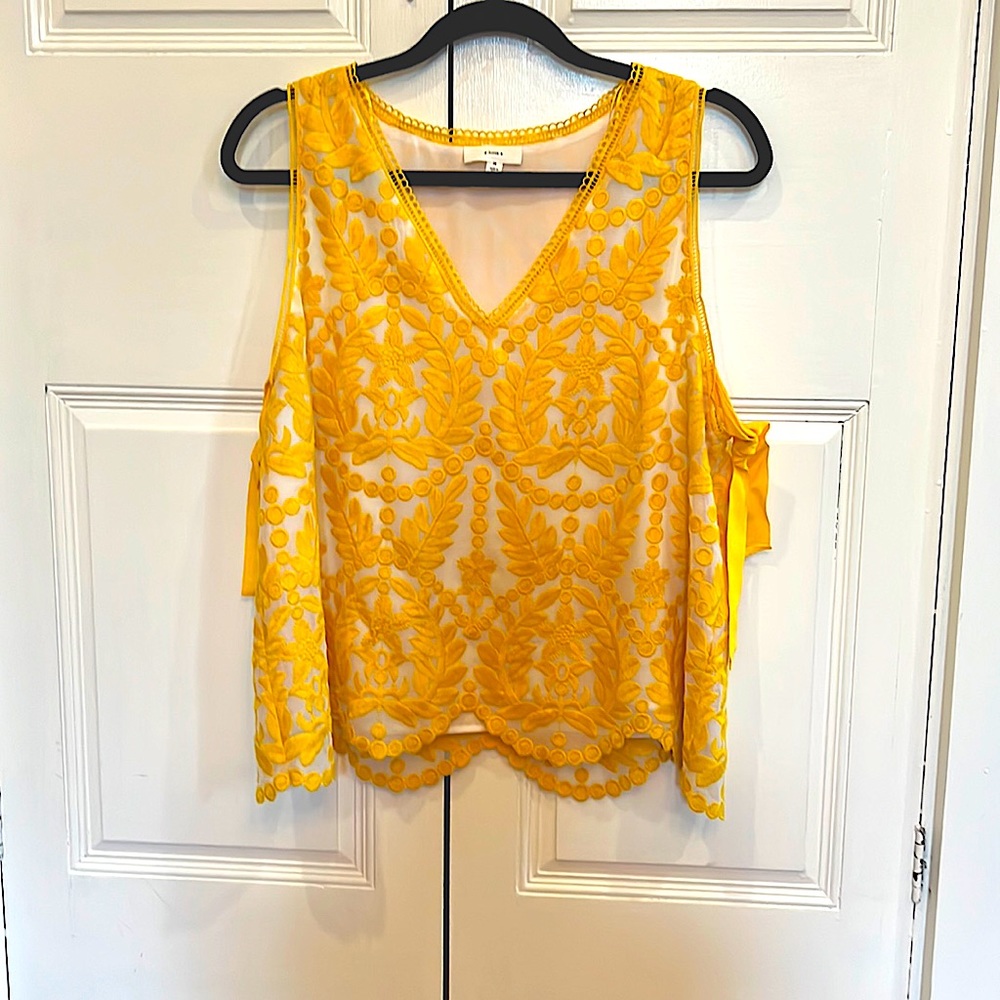 Sleeveless blouse by a loves a beautiful design and color.